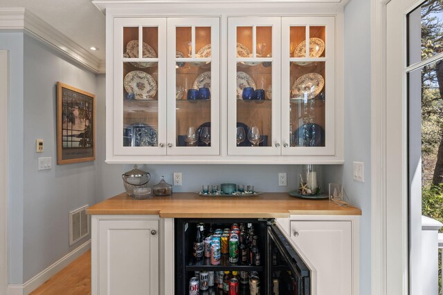 116 Happy Valley Rd, Chatham, MA 02633 - indoor dry bar featuring baseboards, light wood finished floors, recessed lighting, and crown molding
