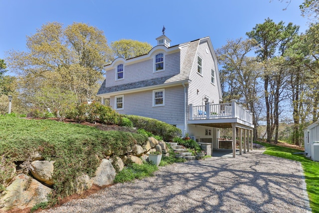 116 Happy Valley Rd, Chatham, MA 02633 - back of property with a deck, a carport, and a gambrel roof
