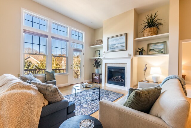 20 Twin Oaks Dr, Mashpee, MA 02649 - living room featuring light wood finished floors, a glass covered fireplace, and baseboards