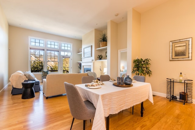 20 Twin Oaks Dr, Mashpee, MA 02649 - dining space with light wood-style floors, a fireplace, baseboards, and built in shelves