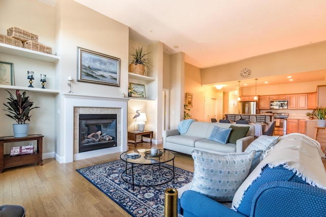 20 Twin Oaks Dr, Mashpee, MA 02649 - living area featuring light wood-style floors, baseboards, and a fireplace