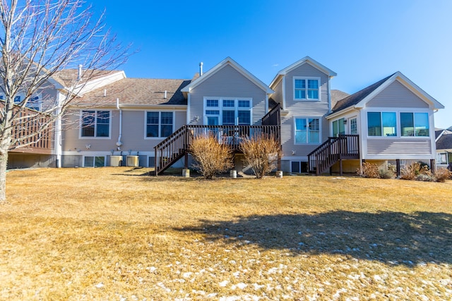 rear view of property with a lawn and a wooden deck