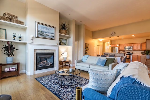 20 Twin Oaks Dr, Mashpee, MA 02649 - living room featuring baseboards, light wood-style floors, and a fireplace