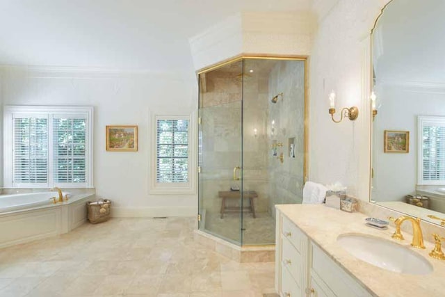 bathroom with crown molding, vanity, and plus walk in shower