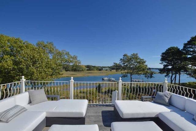 deck featuring a water view and an outdoor hangout area