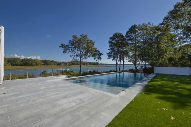 view of swimming pool with a patio, a water view, and a yard