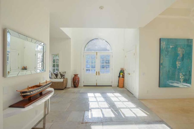 foyer entrance with a wealth of natural light and french doors