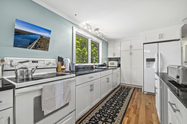215 Head Of The Bay Rd, Buzzards Bay, MA 02532 - kitchen with white appliances, ornamental molding, white cabinetry, light wood-style flooring, and a sink