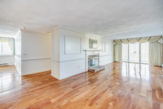 33 Highview Dr, Sandwich, MA 02563 - unfurnished living room featuring a fireplace, plenty of natural light, ornamental molding, and light wood-style flooring