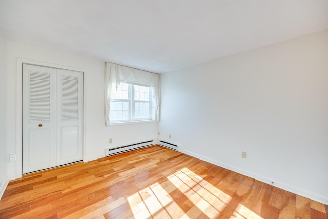 33 Highview Dr, Sandwich, MA 02563 - unfurnished bedroom with light wood-style floors, baseboards, baseboard heating, and a closet