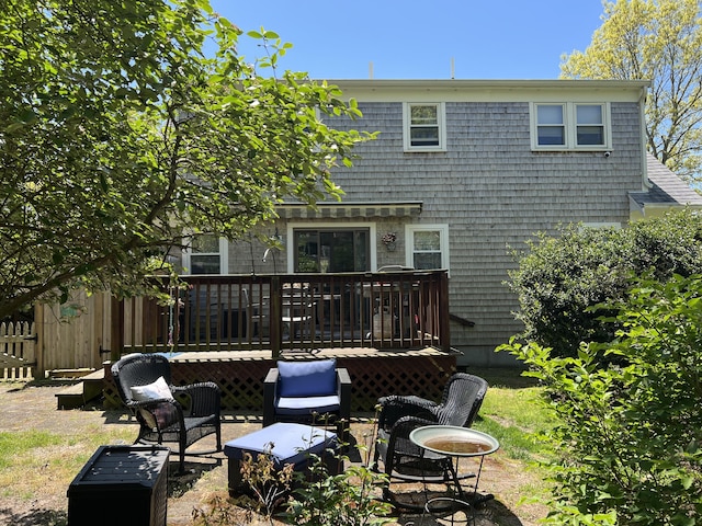 back of property with a wooden deck