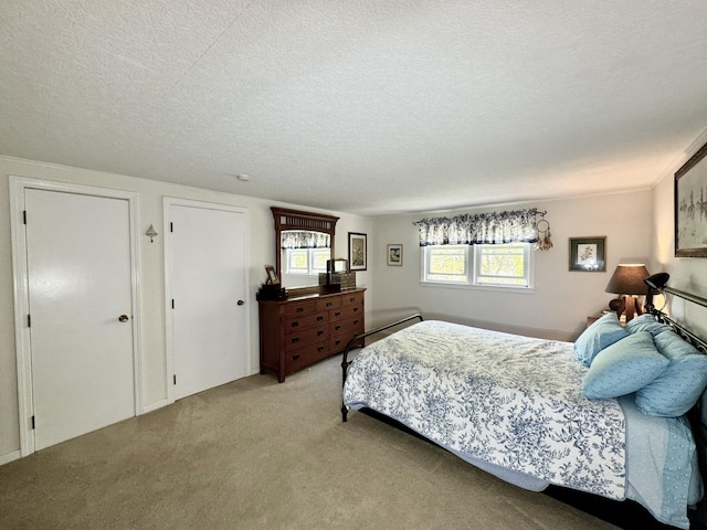 carpeted bedroom featuring a textured ceiling