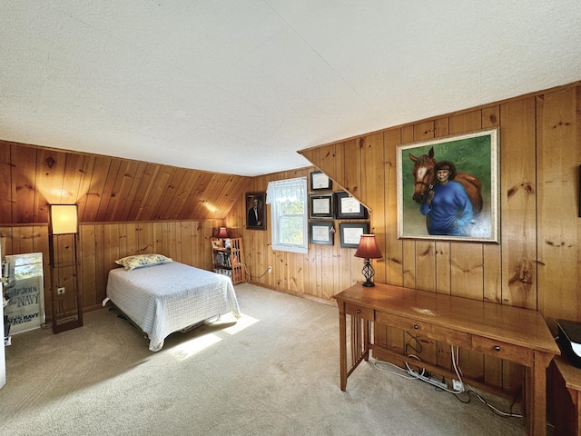 bedroom with vaulted ceiling, wood walls, and light carpet