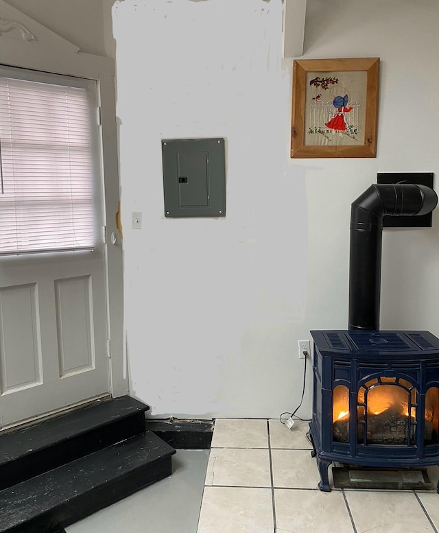 room details featuring a wood stove and electric panel