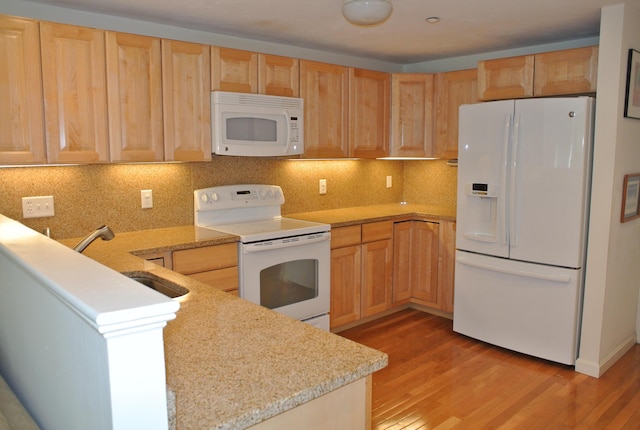 kitchen featuring light hardwood / wood-style flooring, light brown cabinetry, sink, white appliances, and decorative backsplash