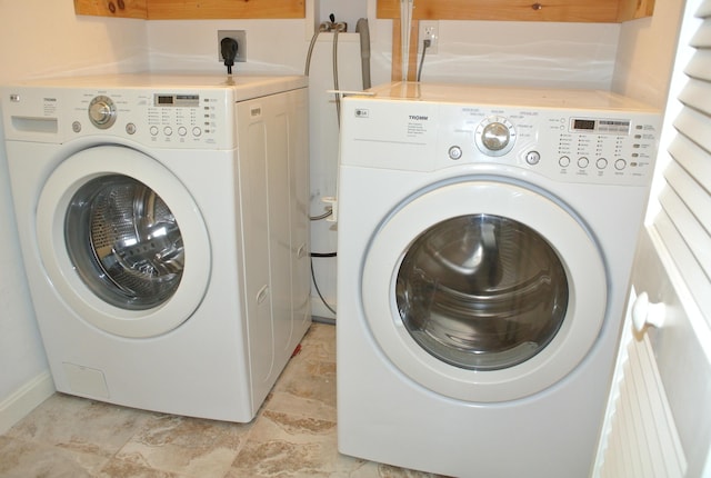 clothes washing area with washing machine and clothes dryer