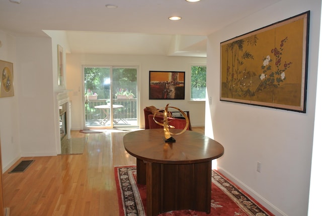 hallway with light hardwood / wood-style floors