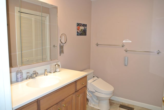 bathroom featuring toilet, tile patterned flooring, and vanity