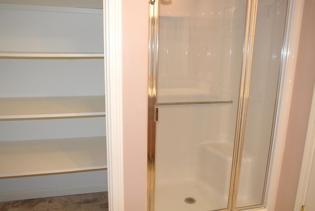 bathroom featuring a shower with shower door