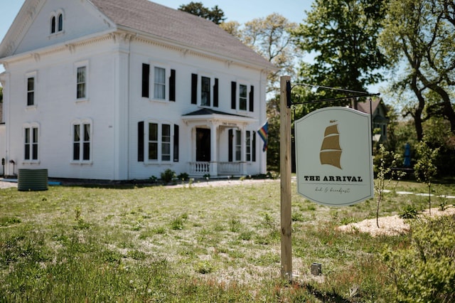 115 Rte 28, West Harwich, MA 02671 - view of front of home with cooling unit and a front lawn