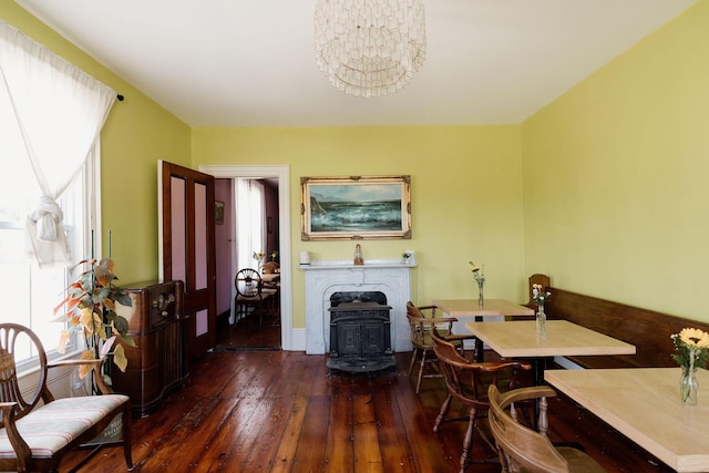 115 Rte 28, West Harwich, MA 02671 - dining space featuring a notable chandelier, a wood stove, and wood-type flooring