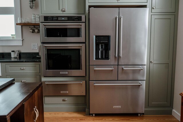 115 Rte 28, West Harwich, MA 02671 - kitchen with dark countertops, a warming drawer, light wood-style floors, and appliances with stainless steel finishes