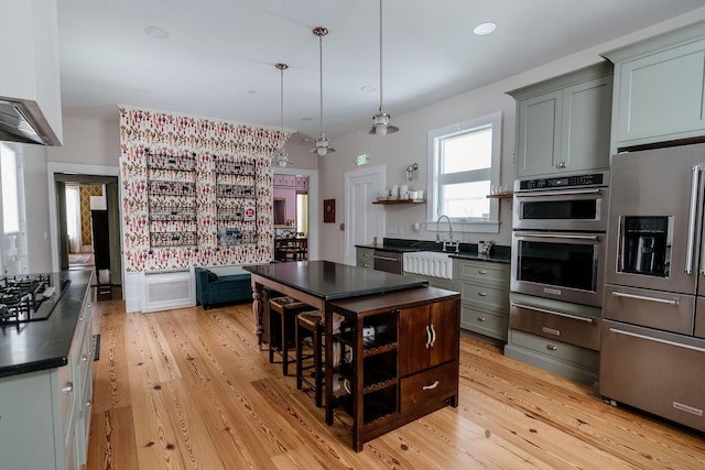 115 Rte 28, West Harwich, MA 02671 - kitchen with a sink, light wood-type flooring, dark countertops, and appliances with stainless steel finishes