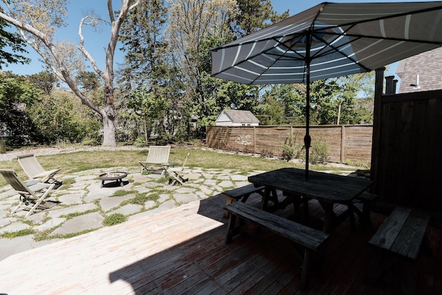 115 Rte 28, West Harwich, MA 02671 - view of patio with outdoor dining area, a fire pit, and fence