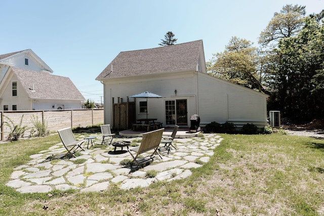 115 Rte 28, West Harwich, MA 02671 - back of property featuring fence, roof with shingles, a fire pit, a patio area, and a lawn