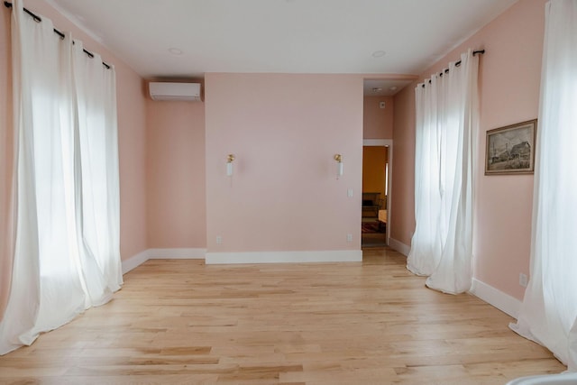 115 Rte 28, West Harwich, MA 02671 - unfurnished room with baseboards, light wood-type flooring, and a wall unit AC