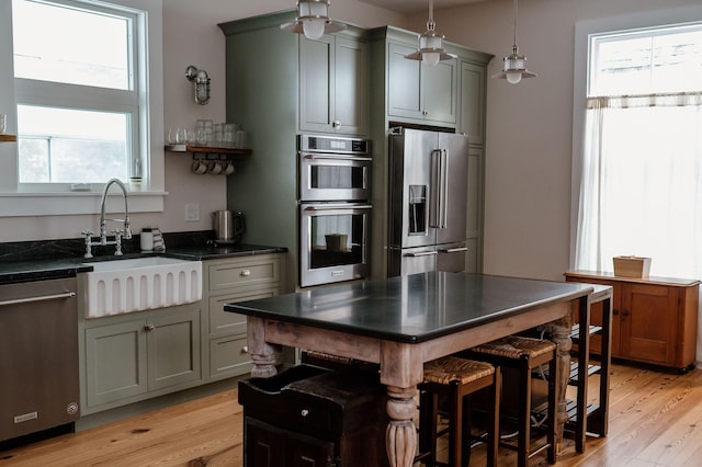 115 Rte 28, West Harwich, MA 02671 - kitchen featuring a sink, decorative light fixtures, light wood finished floors, and stainless steel appliances