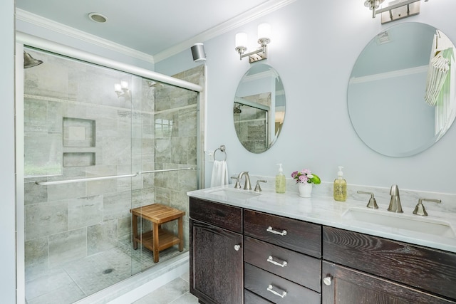 full bath with a shower stall, a sink, and crown molding