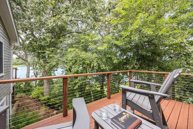 wooden deck featuring a water view