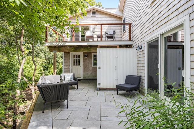 view of patio / terrace with a balcony and an outdoor hangout area