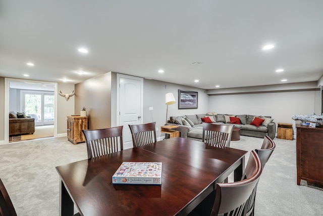 dining room with recessed lighting and light colored carpet