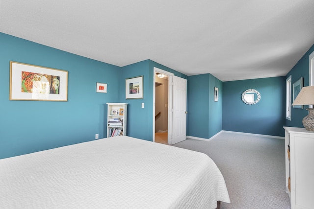 carpeted bedroom with baseboards