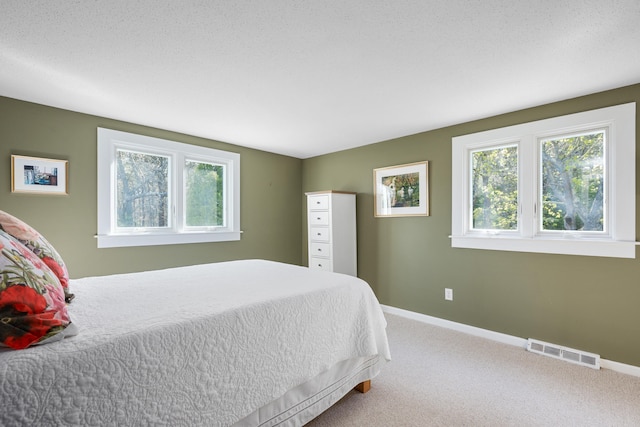 carpeted bedroom featuring baseboards