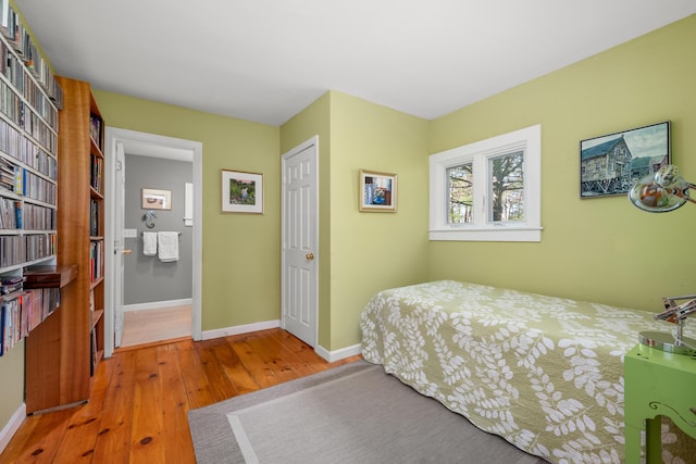 bedroom with hardwood / wood-style floors and baseboards