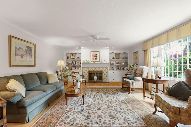 8 Viking Rock Rd, South Yarmouth, MA 02664 - living area with plenty of natural light, crown molding, ceiling fan, a tile fireplace, and built in shelves