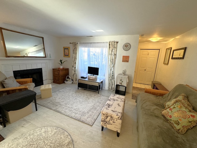 living room with a tiled fireplace