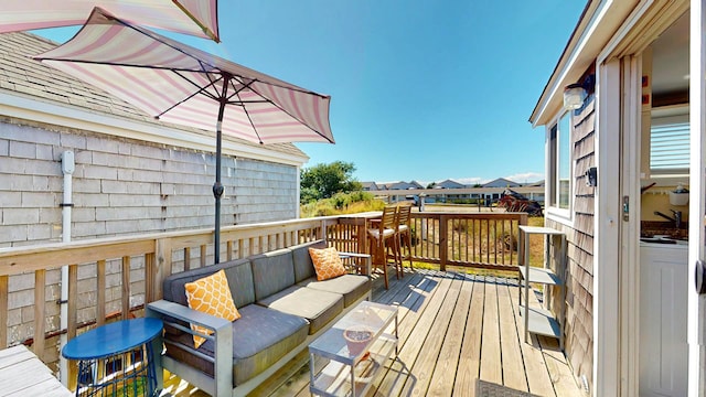 wooden terrace with an outdoor hangout area