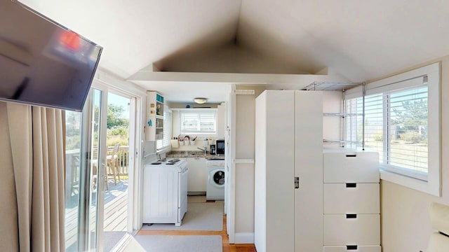 laundry room with a healthy amount of sunlight and washer and dryer