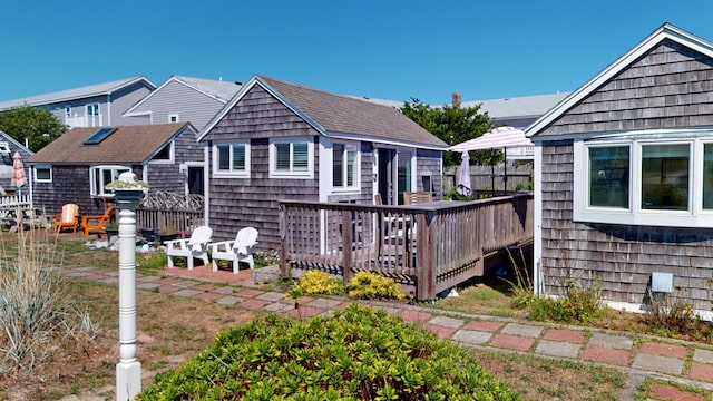 rear view of property featuring a deck