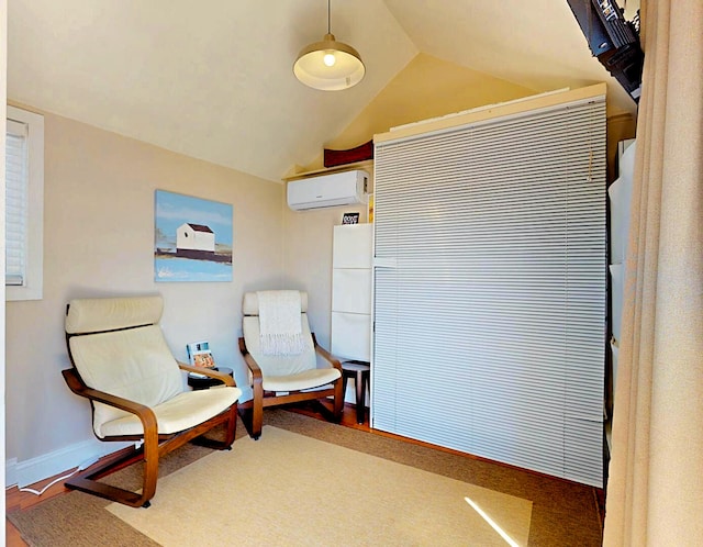 living area featuring an AC wall unit and lofted ceiling