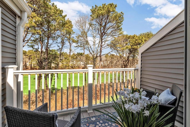 wooden deck featuring a yard