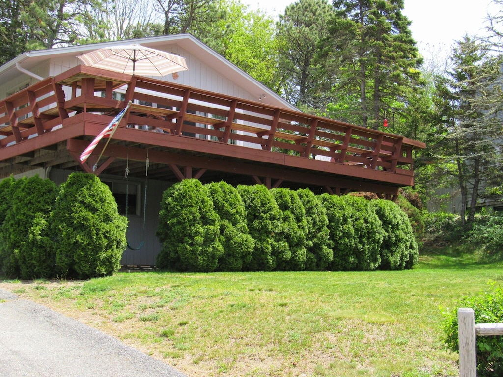 exterior space featuring a lawn and a deck