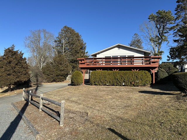 view of property exterior with a deck