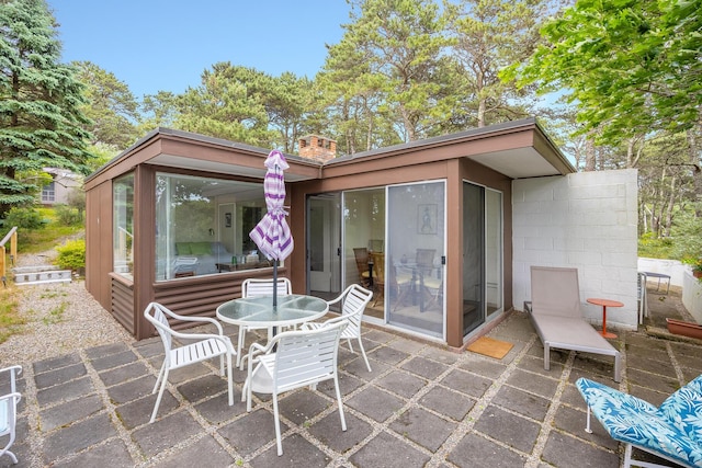 view of patio with a sunroom