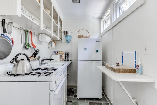 kitchen featuring sink, white appliances, and white cabinets