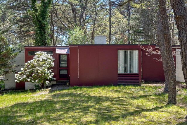 view of outbuilding featuring a lawn